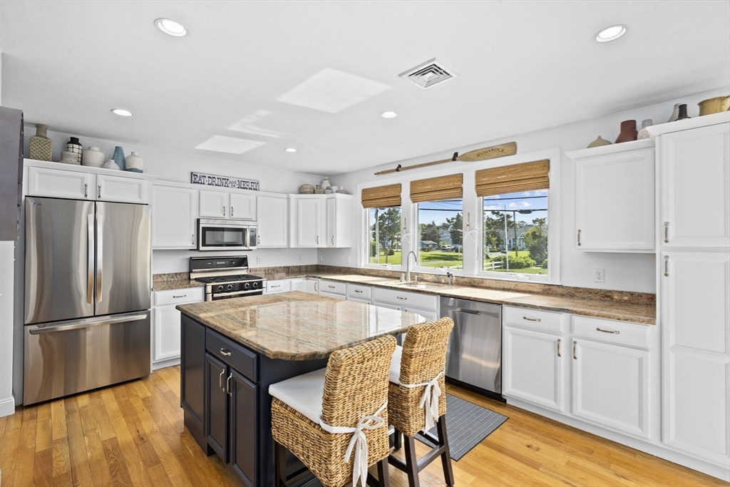 98 Central Avenue Scituate, MA 02066 - Photo 5 of 37 a kitchen with stainless steel appliances granite countertop a stove refrigerator sink and cabinets