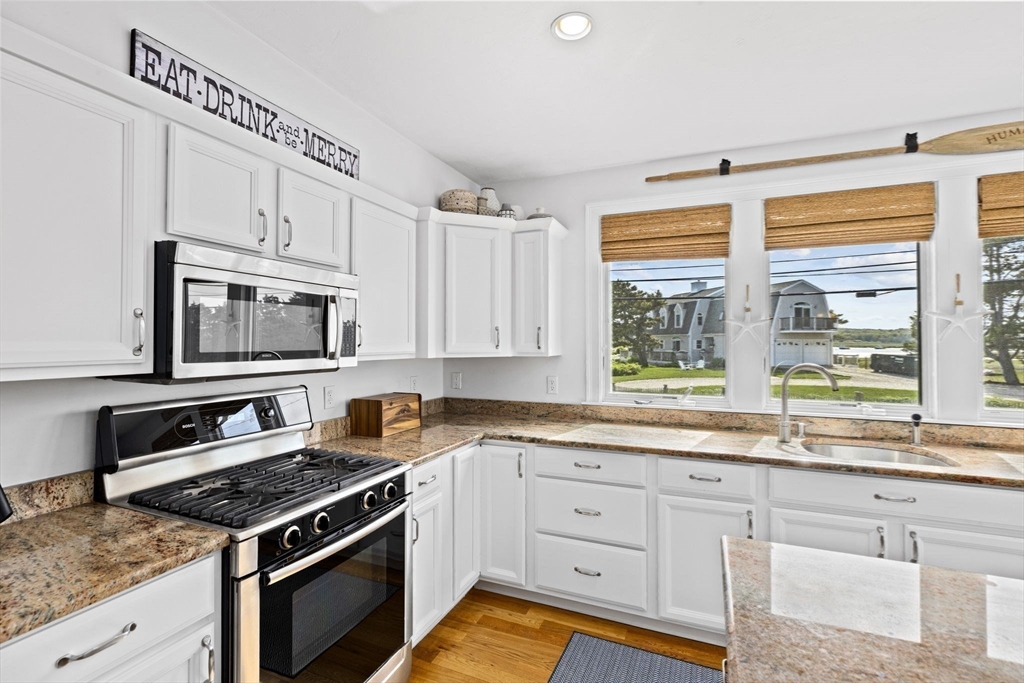 98 Central Avenue Scituate, MA 02066 - Photo 7 of 37 a kitchen with stainless steel appliances white cabinets stove and sink