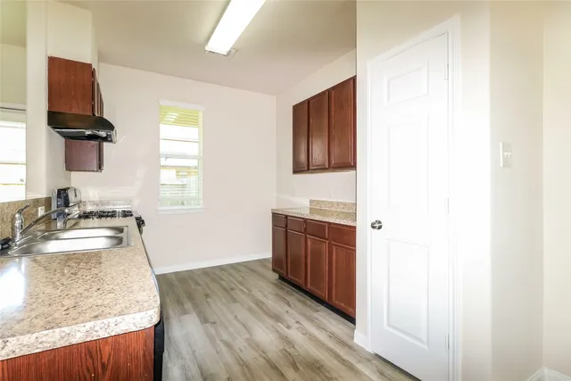 a spacious bathroom with a granite countertop sink and a mirror