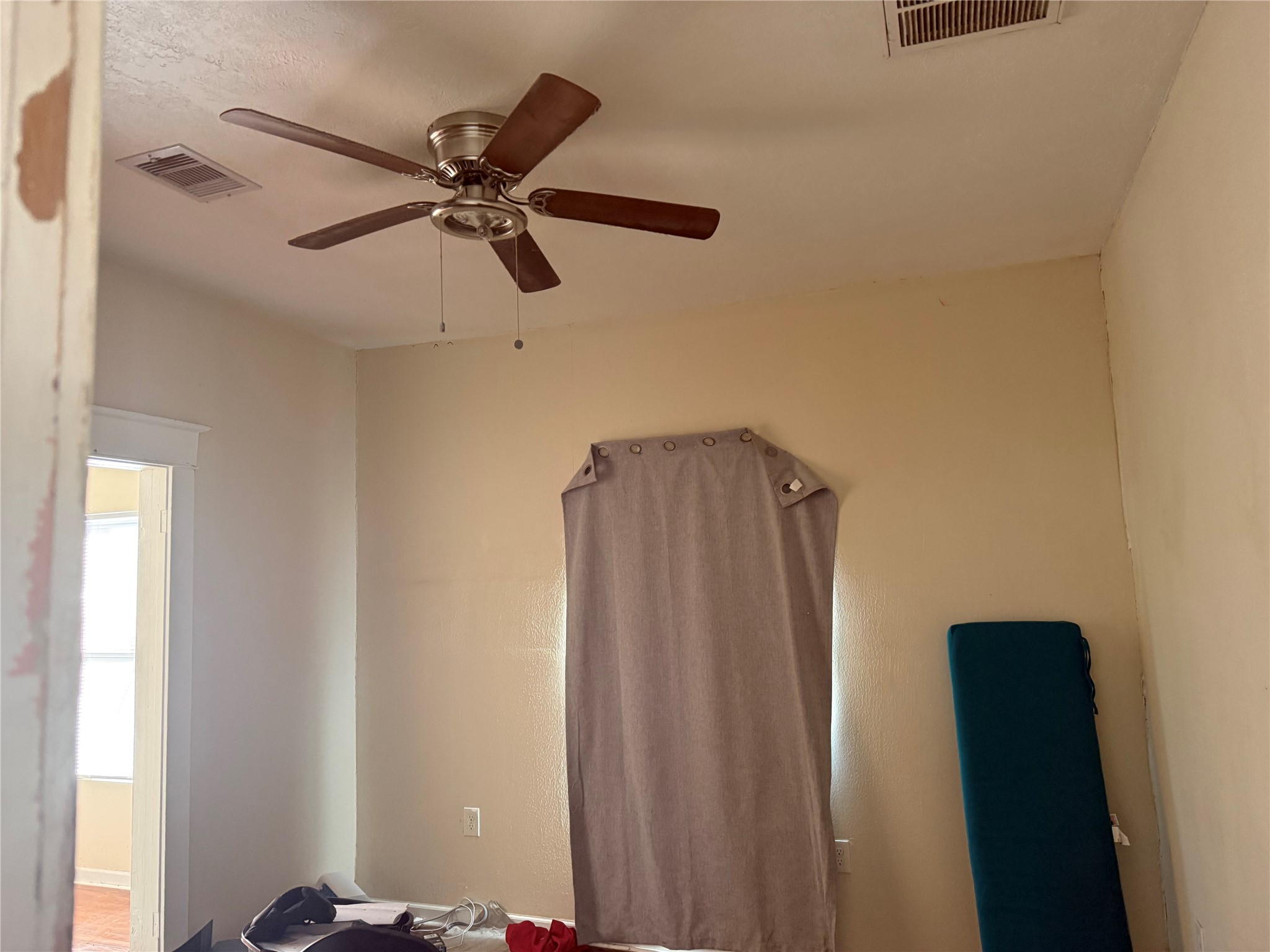 185 Woodvale Street Houston, TX 77012 - Photo 6 of 9 a view of a hallway with a ceiling fan and a window