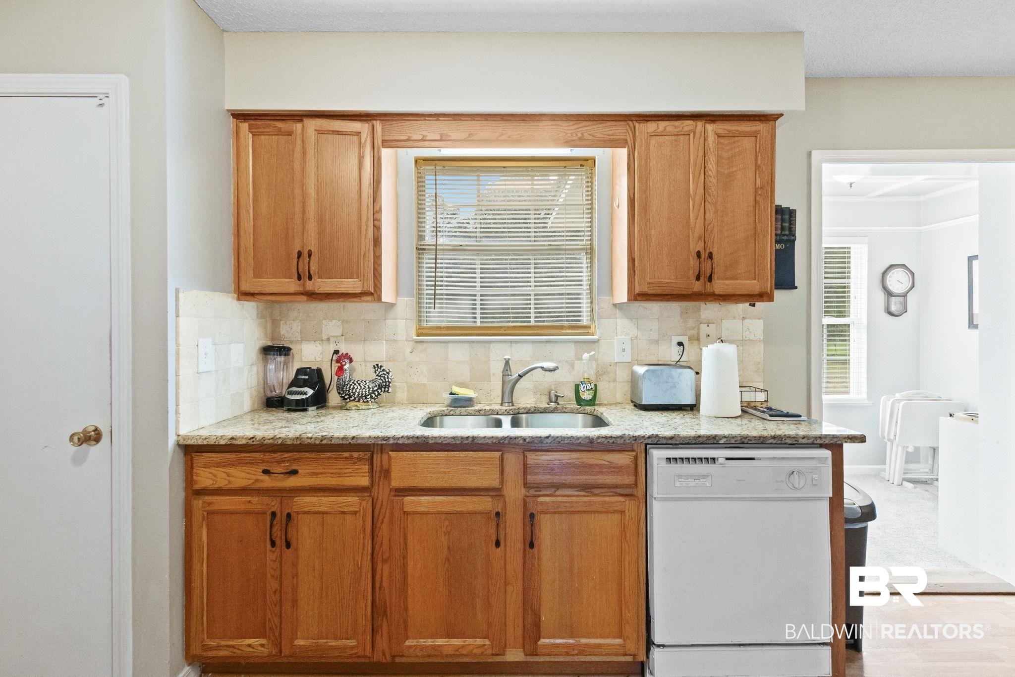 14031 Brook Hollow Road Summerdale, AL 36580 - Photo 21 of 56 Kitchen with backsplash, sink, and white dishwasher