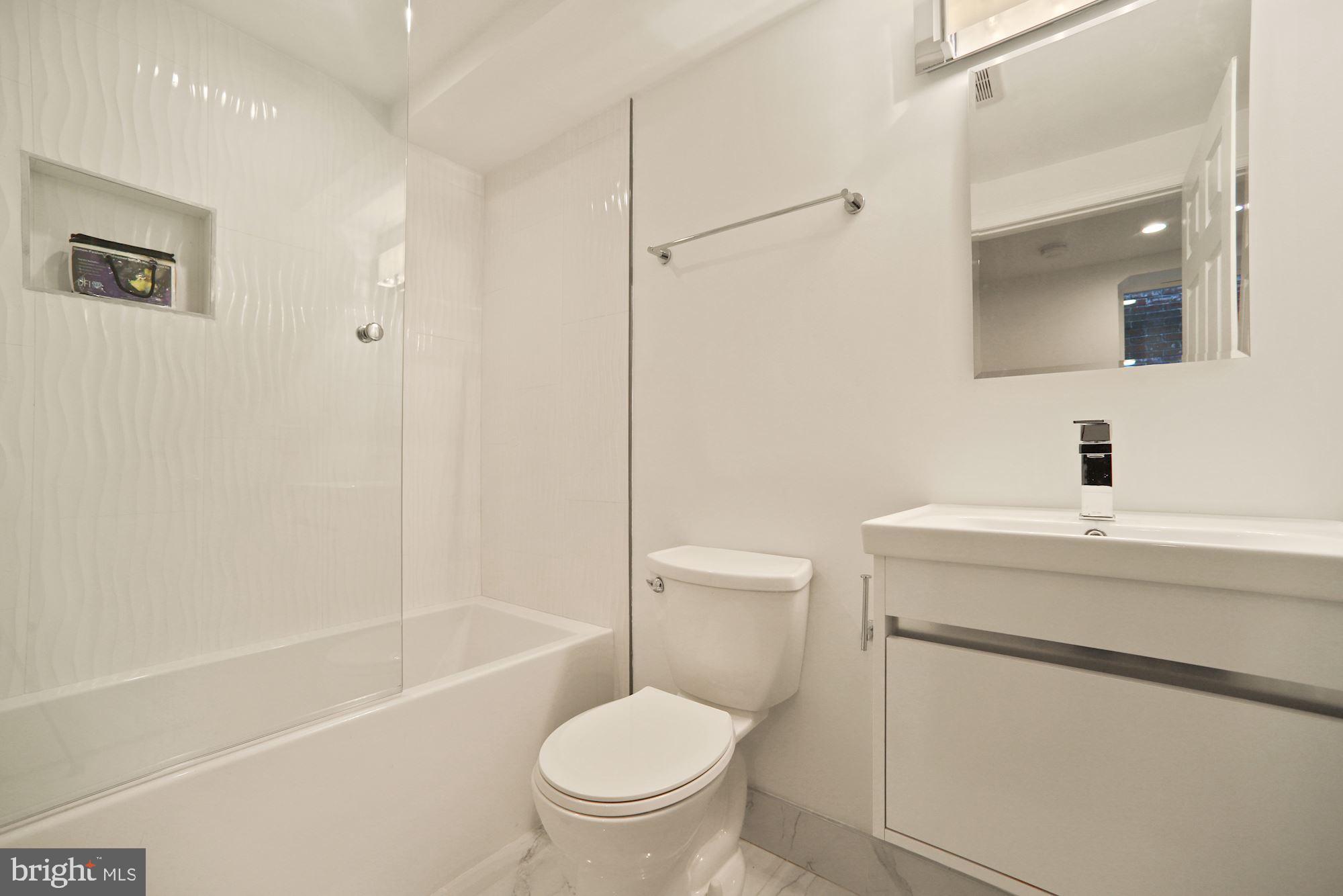 1215 S Street Northwest, Unit B Washington, DC 20009 - Photo 15 of 18 a bathroom with a sink toilet and shower