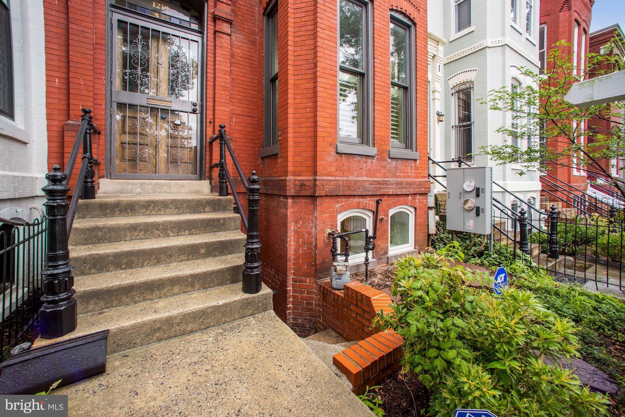 1215 S Street Northwest, Unit B Washington, DC 20009 - Photo 2 of 18 front view of a brick house with a large windows