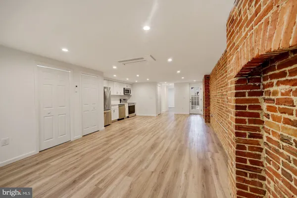 a view of a hall with wooden floor