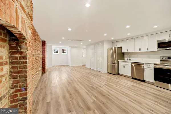 a view of kitchen with stainless steel appliances granite countertop a stove and a refrigerator