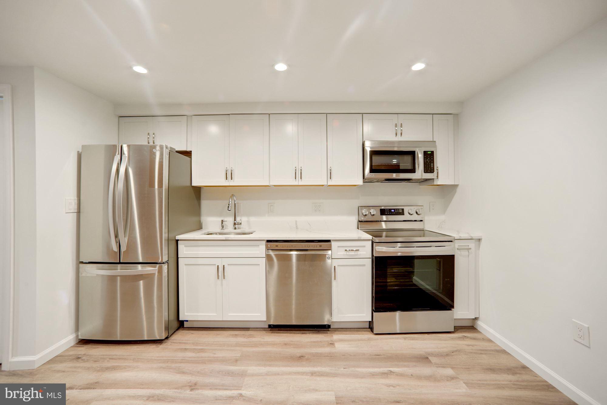 1215 S Street Northwest, Unit B Washington, DC 20009 - Photo 9 of 18 a kitchen with a refrigerator stove and microwave