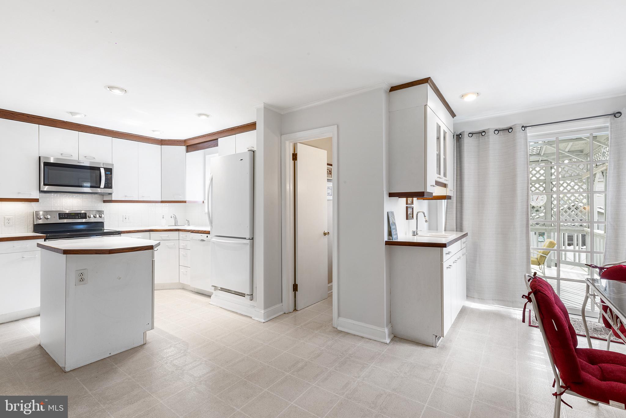 325 Wyndmoor Road Springfield, PA 19064 - Photo 11 of 45 a kitchen with white cabinets and refrigerator