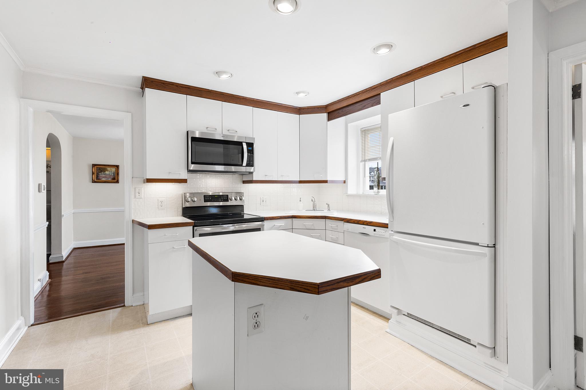 325 Wyndmoor Road Springfield, PA 19064 - Photo 12 of 45 a white refrigerator freezer sitting in a kitchen