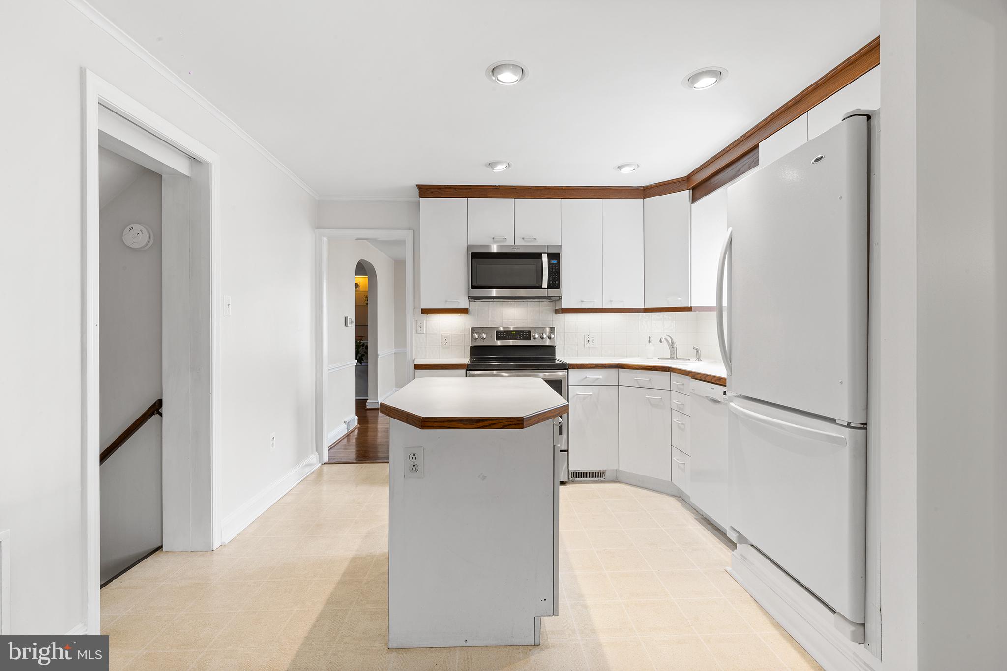 325 Wyndmoor Road Springfield, PA 19064 - Photo 13 of 45 a kitchen with stainless steel appliances granite countertop a refrigerator a stove and a sink