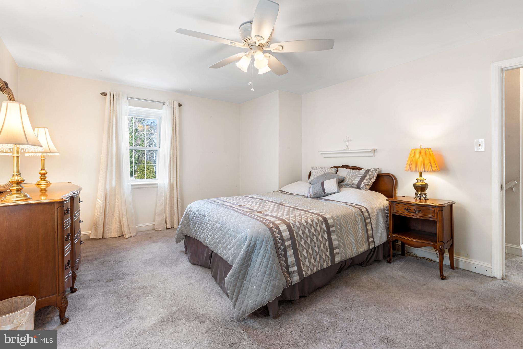 325 Wyndmoor Road Springfield, PA 19064 - Photo 17 of 45 a bedroom with a bed and a chandelier