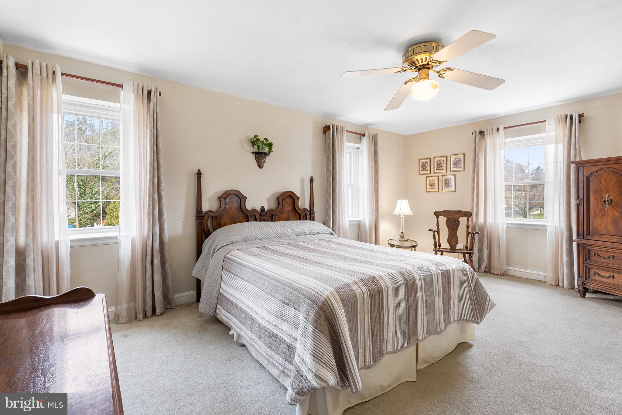 325 Wyndmoor Road Springfield, PA 19064 - Photo 18 of 45 a bedroom with a bed and a chandelier