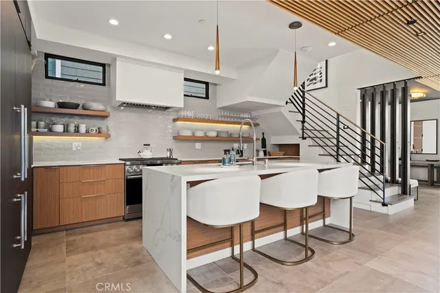 a kitchen with cabinets and chairs
