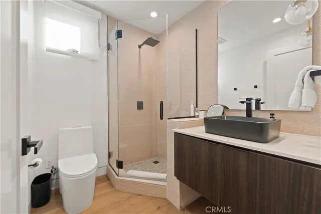 a bathroom with a double vanity sink toilet and shower