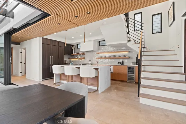 a kitchen with a table chairs stove and cabinets