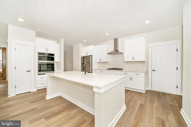 a large kitchen with stainless steel appliances granite countertop a stove and a sink