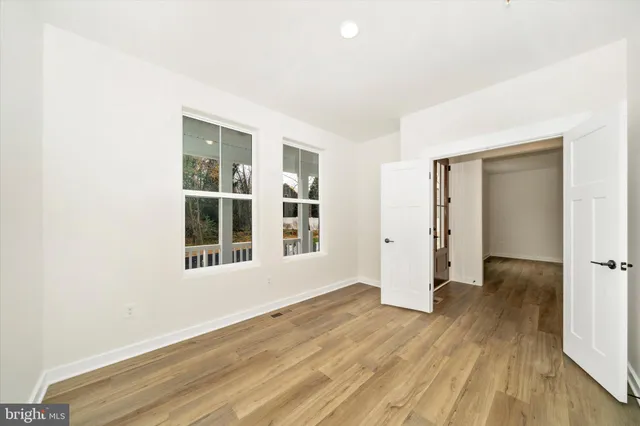 a bedroom with a large bed and a large window
