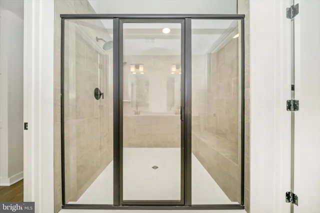 a bathroom with a double vanity sink toilet mirror and shower