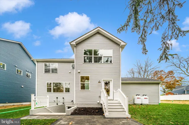 a view of a yard with plants and wooden fence