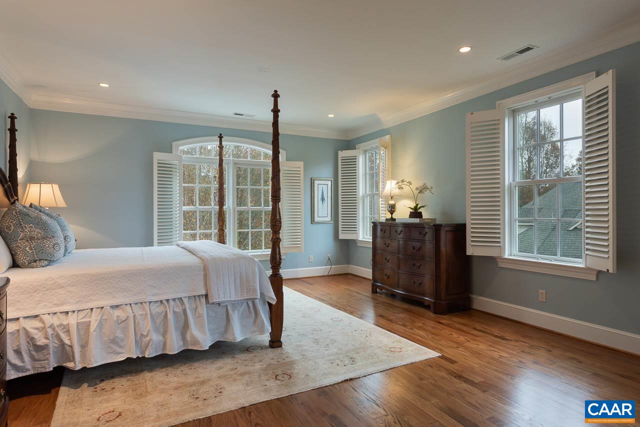 3104 Darby Road Keswick, VA 22947 - Photo 20 of 43 a bedroom with a bed and wooden floor