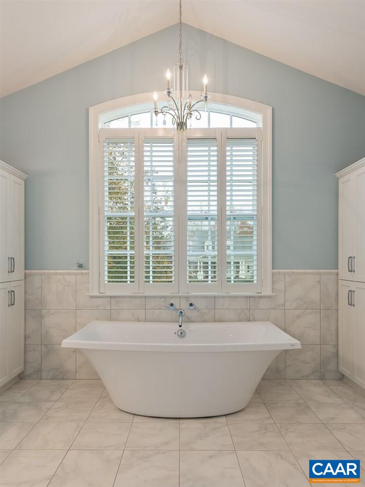 3104 Darby Road Keswick, VA 22947 - Photo 23 of 43 a bath tub sitting in a bathroom next to a window