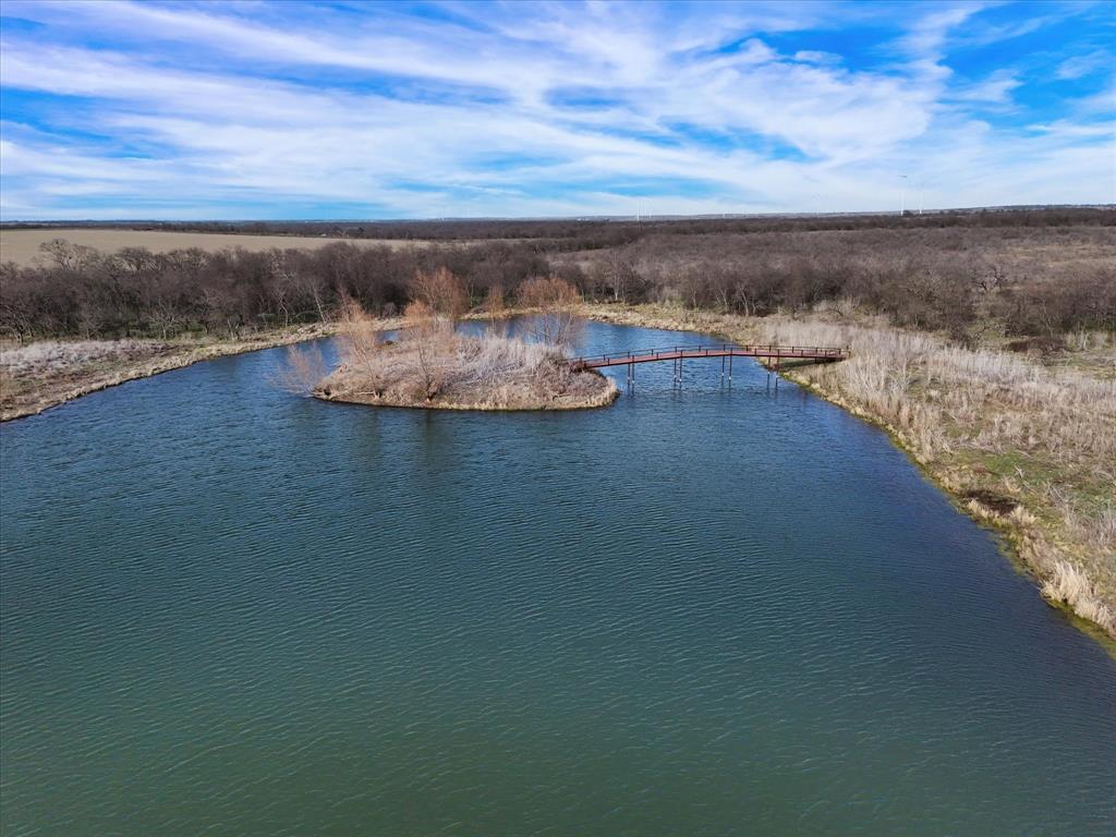 9784 County Line Road South Mount Calm, TX 76673 - Photo 8 of 15 a view of a lake with a mountain