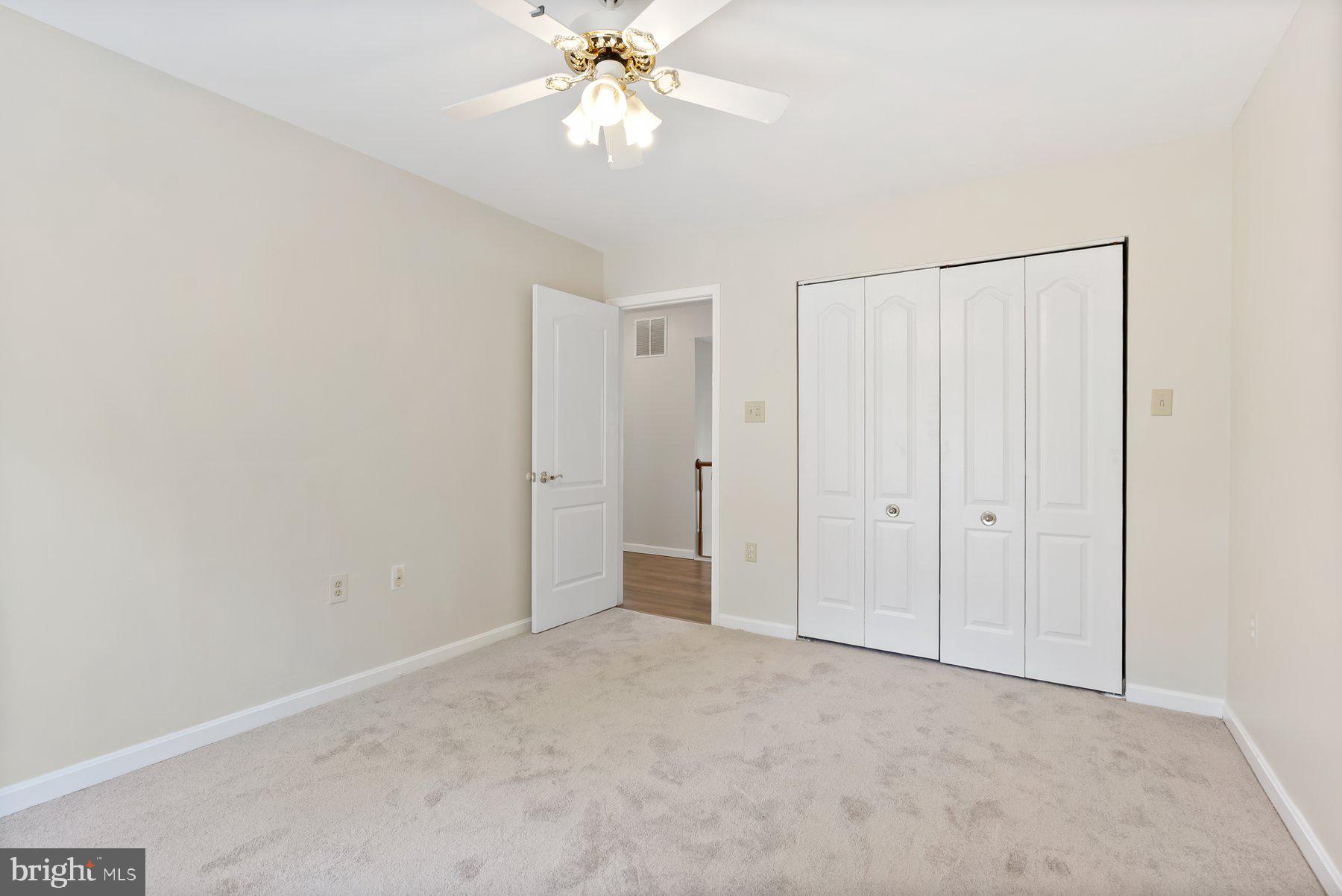 13 Bellinger Court Reisterstown, MD 21136 - Photo 21 of 37 an empty room with a ceiling fan and a window