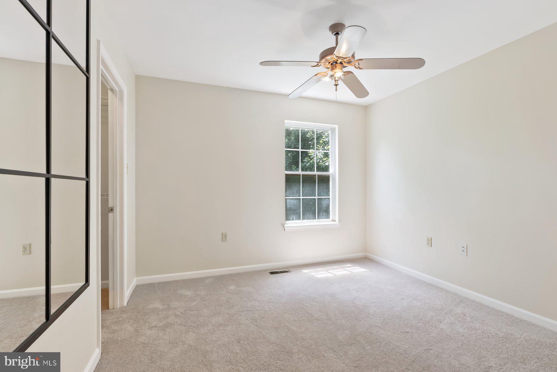 13 Bellinger Court Reisterstown, MD 21136 - Photo 22 of 37 an empty room with windows and fan