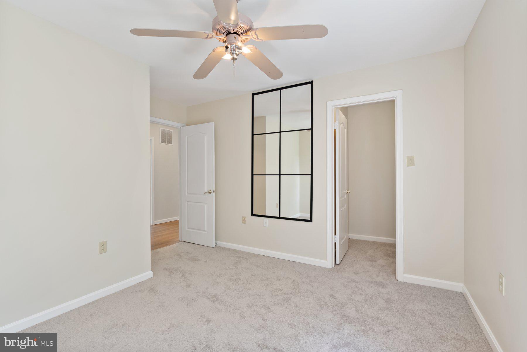 13 Bellinger Court Reisterstown, MD 21136 - Photo 23 of 37 an empty room with windows and fan