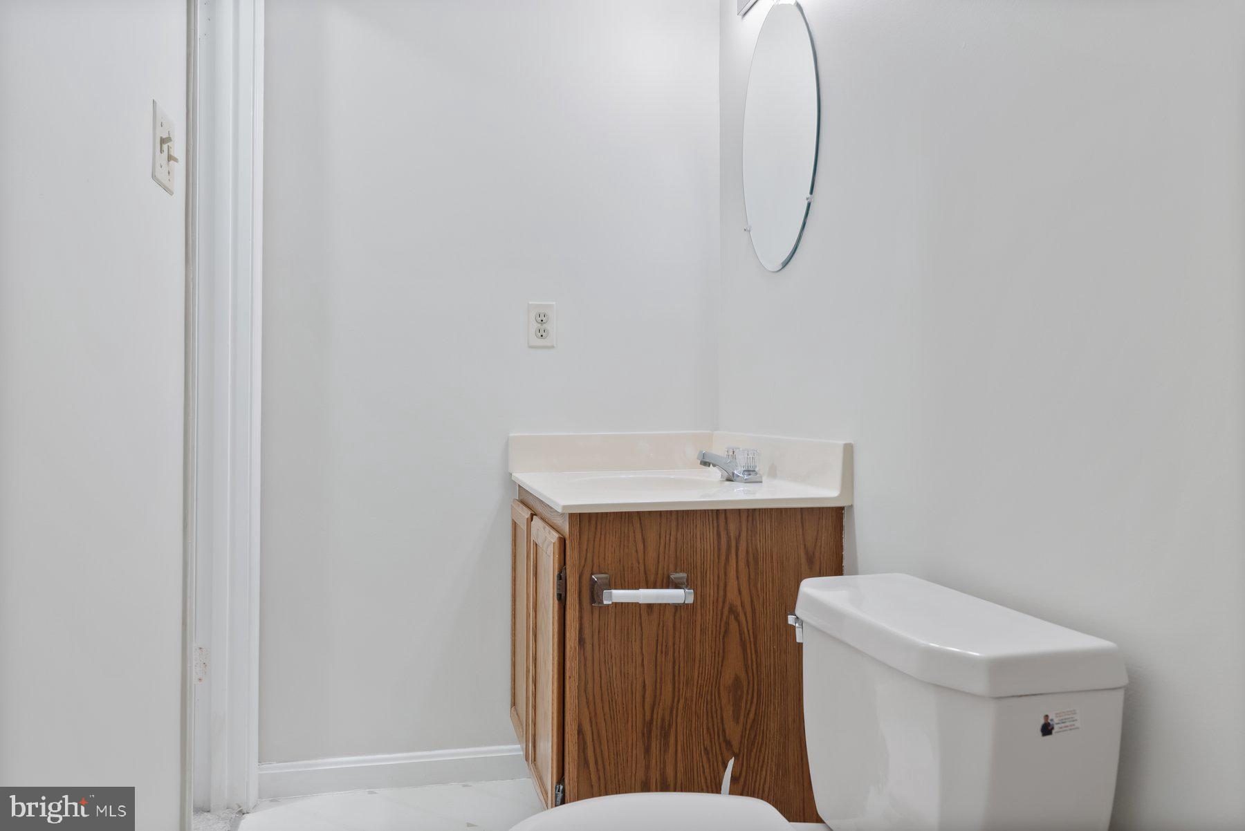 13 Bellinger Court Reisterstown, MD 21136 - Photo 30 of 37 a utility room with a sink a toilet and vanity