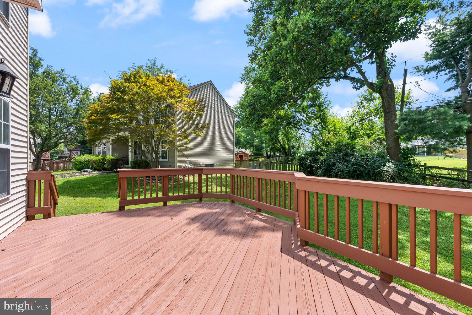 13 Bellinger Court Reisterstown, MD 21136 - Photo 36 of 37 a view of a deck with wooden floor and fence next to a yard