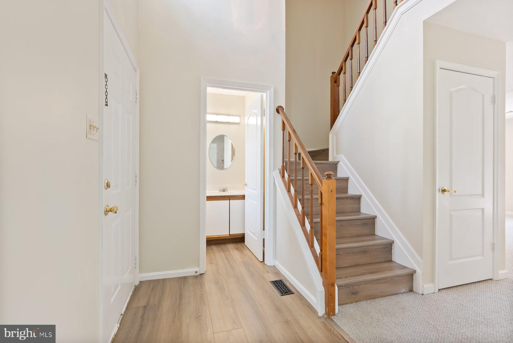 13 Bellinger Court Reisterstown, MD 21136 - Photo 5 of 37 a view of a hallway with wooden floor and entryway