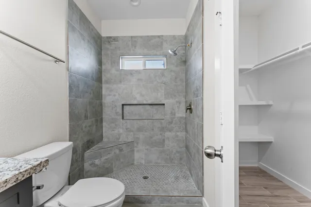a bathroom with a toilet and a shower