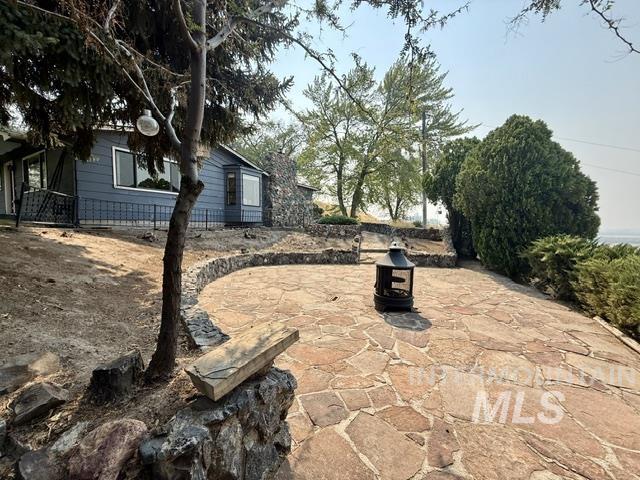 1549 Cove Road Weiser, ID 83672 - Photo 29 of 38 Expansive flagstone patio with a curved stone retaining wall