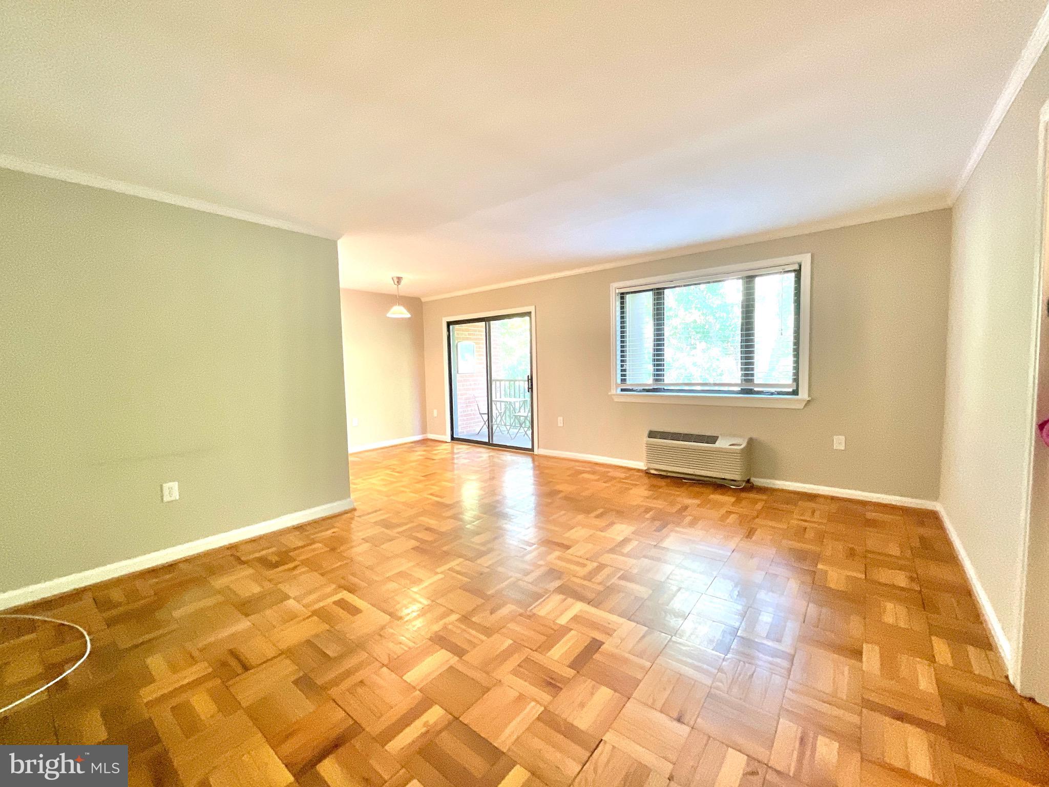 4114 Davis Place Northwest, Unit 210 Washington, DC 20007 - Photo 5 of 19 a view of an empty room with window and a kitchen