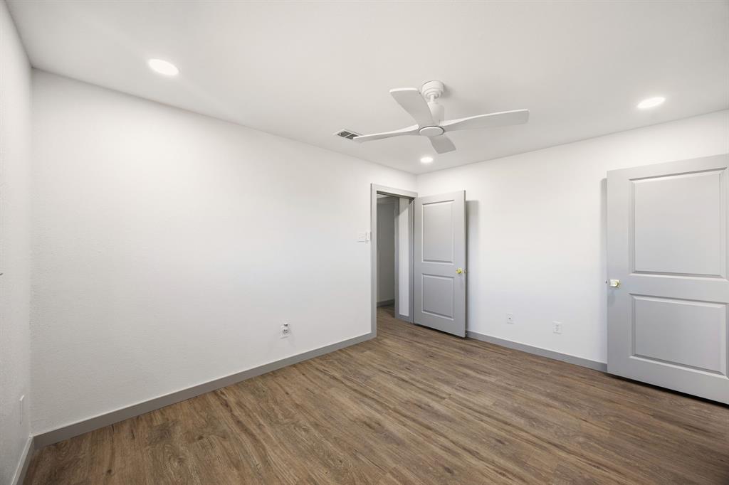 617 Reed Street Roanoke, TX 76262 - Photo 19 of 35 an empty room with wooden floor and windows