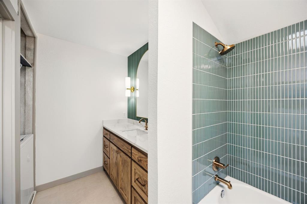 617 Reed Street Roanoke, TX 76262 - Photo 21 of 35 a bathroom with a sink a vanity and shower