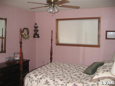2303 Sage Rd Mount Long Pond, PA 18334 - Photo 6 of 15 a bedroom with a bed and a window