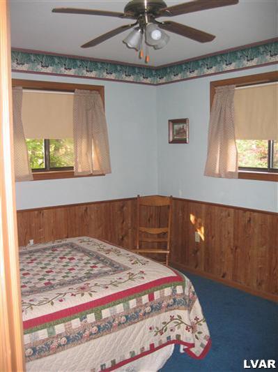 2303 Sage Rd Mount Long Pond, PA 18334 - Photo 8 of 15 a bedroom with a bed and painting on the wall