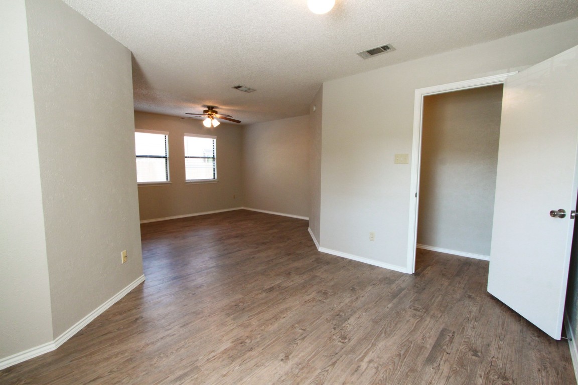 605 Timber Trail Cedar Park, TX 78613 - Photo 17 of 36 an empty room with wooden floor and windows