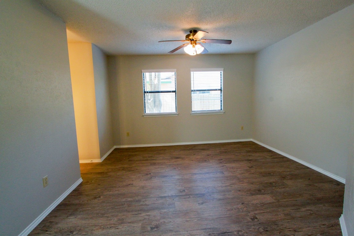 605 Timber Trail Cedar Park, TX 78613 - Photo 20 of 36 a view of an empty room with a window and wooden floor