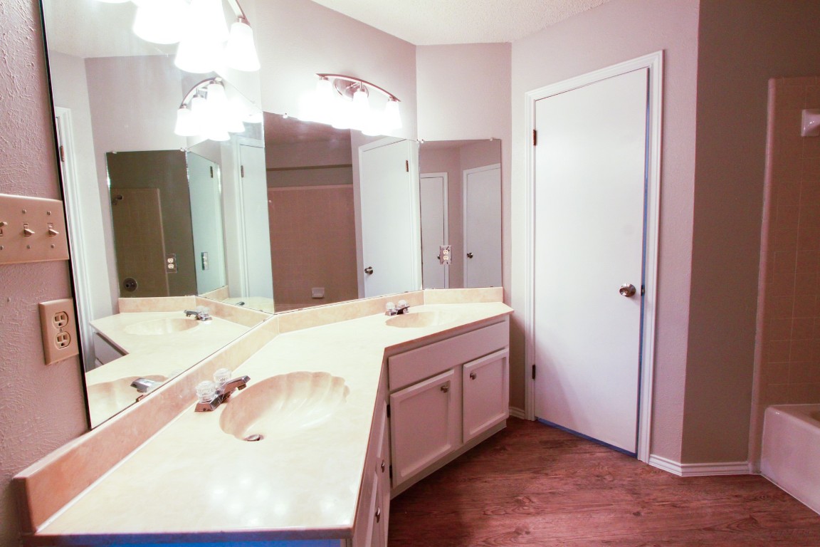605 Timber Trail Cedar Park, TX 78613 - Photo 22 of 36 a bathroom with a tub sink and mirror