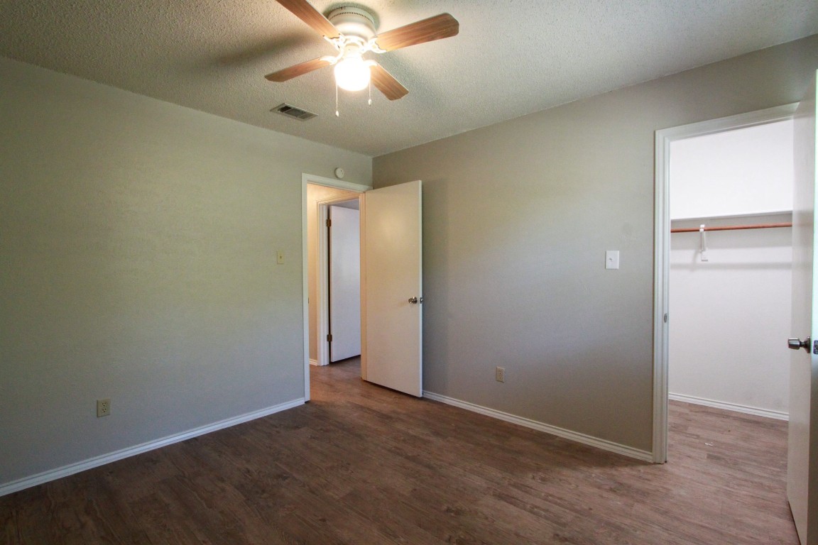 605 Timber Trail Cedar Park, TX 78613 - Photo 28 of 36 an empty room with closet and a chandelier fan