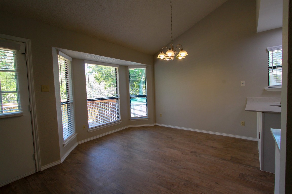 605 Timber Trail Cedar Park, TX 78613 - Photo 10 of 36 an empty room with wooden floor and windows