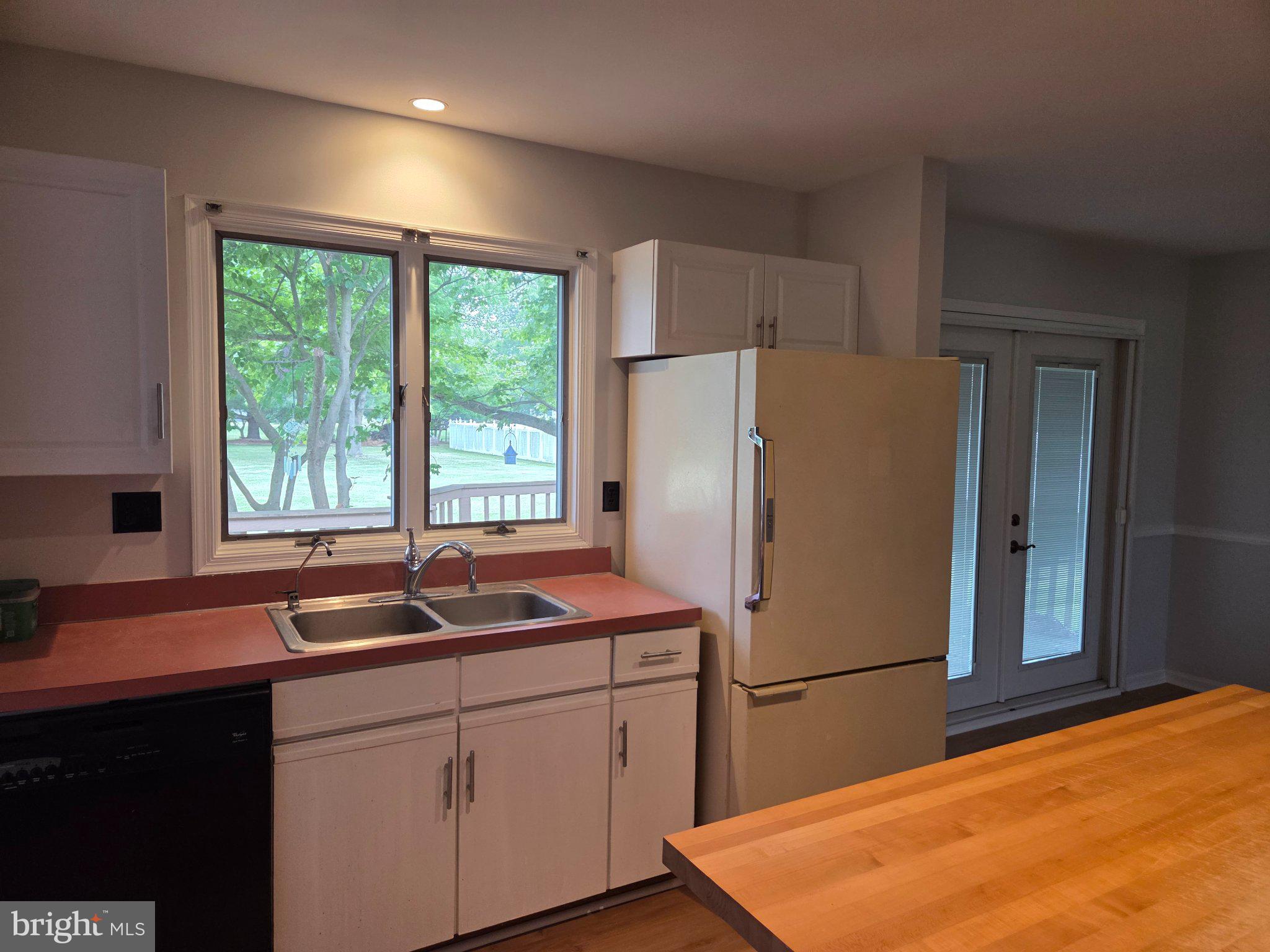 1378 Woodlytown Road Magnolia, DE 19962 - Photo 12 of 15 a kitchen with a refrigerator a sink and a window