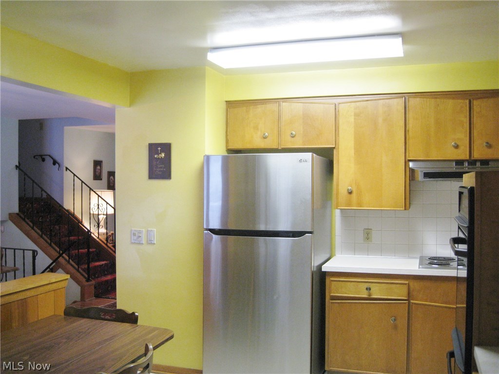 105 Trunko Road Akron, OH 44333 - Photo 9 of 21 Kitchen. LG Refrigerator stays. Entrance to Garage on right.
