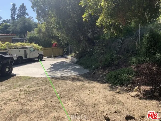 a view of a yard with car parked