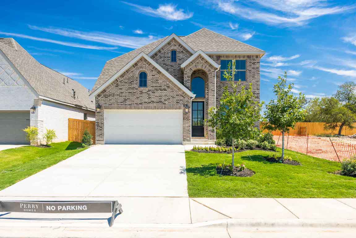 213 Adali Avenue Georgetown, TX 78633 - Photo 2 of 16 View of front of house with brick siding, roof with shingles, and concrete driveway