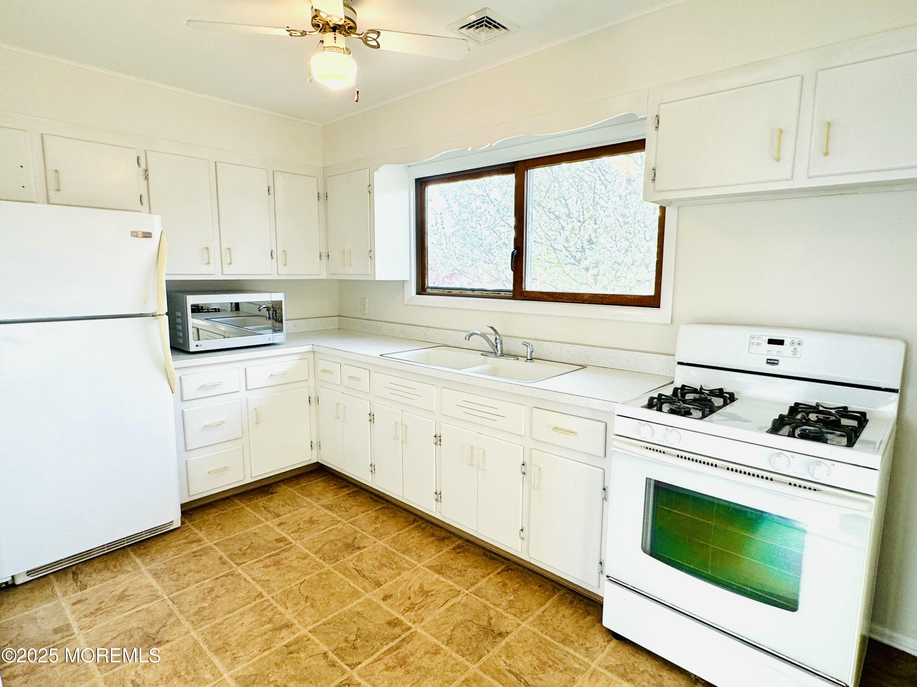 922 Capstan Drive Forked River, NJ 08731 - Photo 13 of 26 a kitchen with a stove a sink and a refrigerator