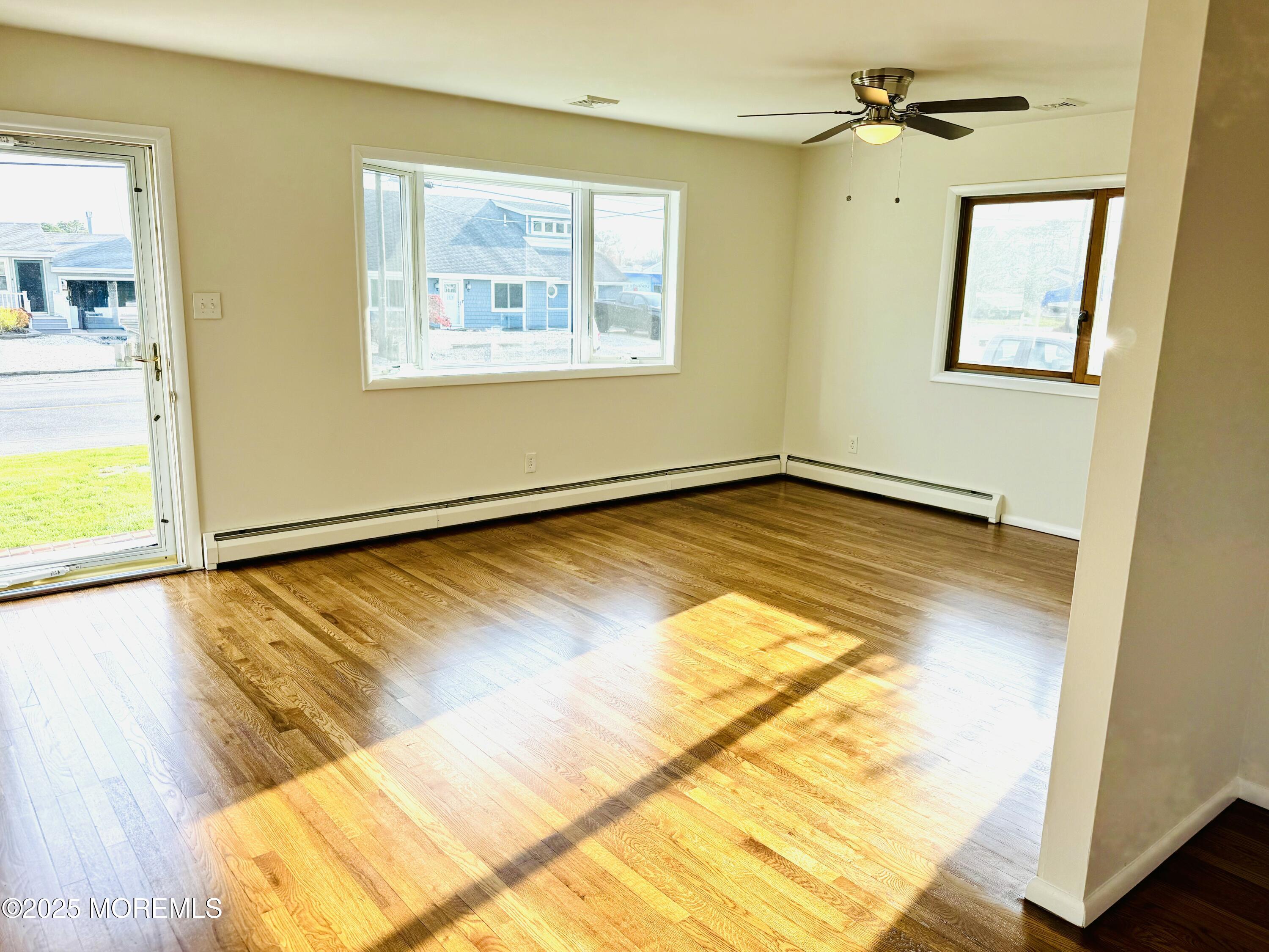 922 Capstan Drive Forked River, NJ 08731 - Photo 4 of 26 a view of an empty room and wooden floor