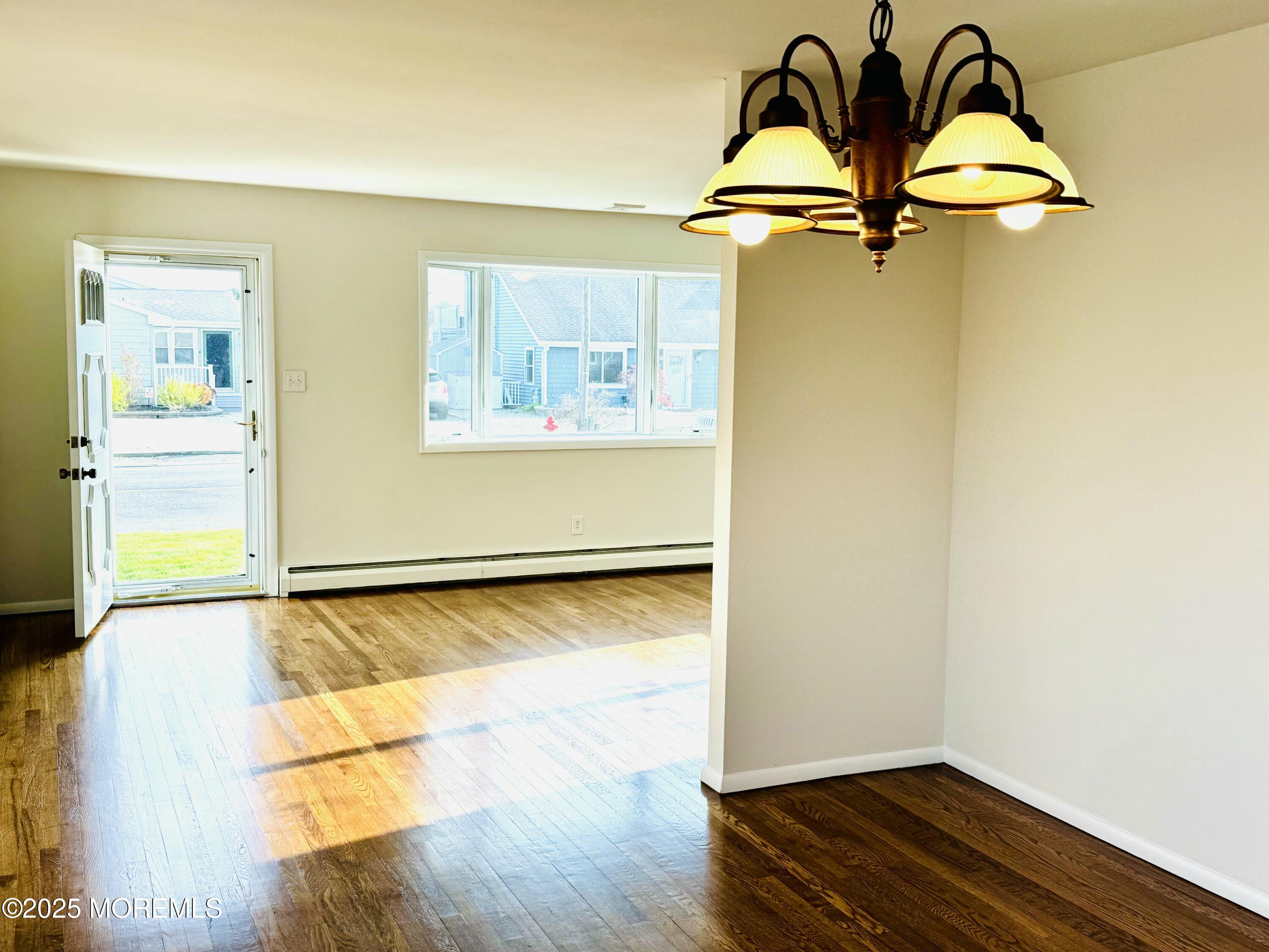 922 Capstan Drive Forked River, NJ 08731 - Photo 6 of 26 a room with a wooden floor and window